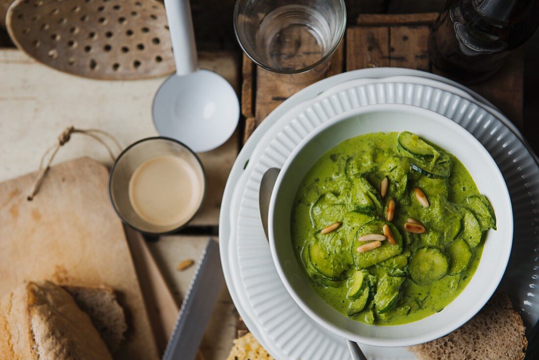 Courgette stew with pesto and pine nuts