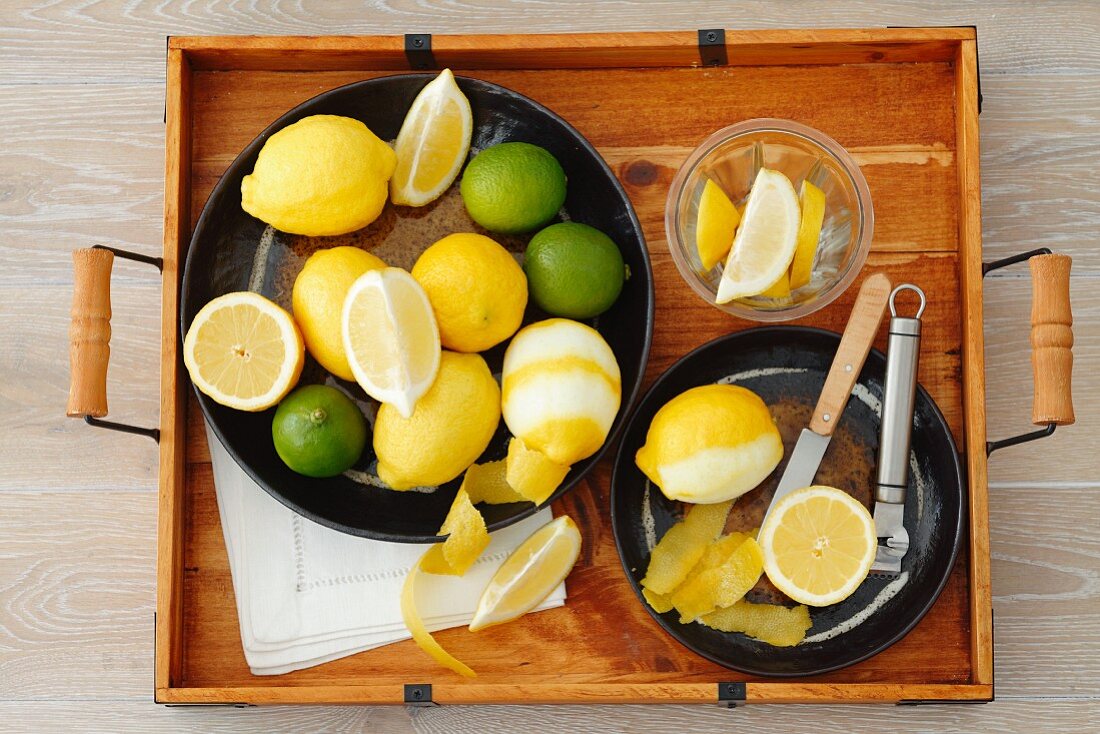 Lemons and limes (whole, cut in half, wedges and lemon peel)