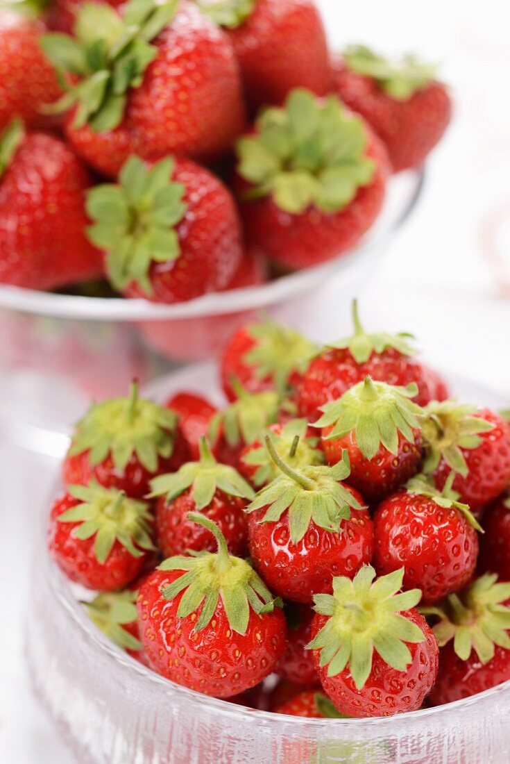 Fresh strawberries in glass bowls