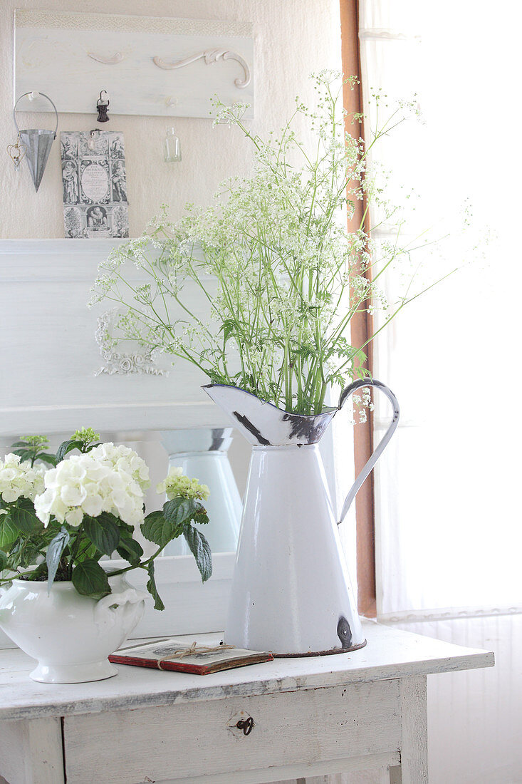 Wild flowers in enamel jug and hydrangeas in soup tureen