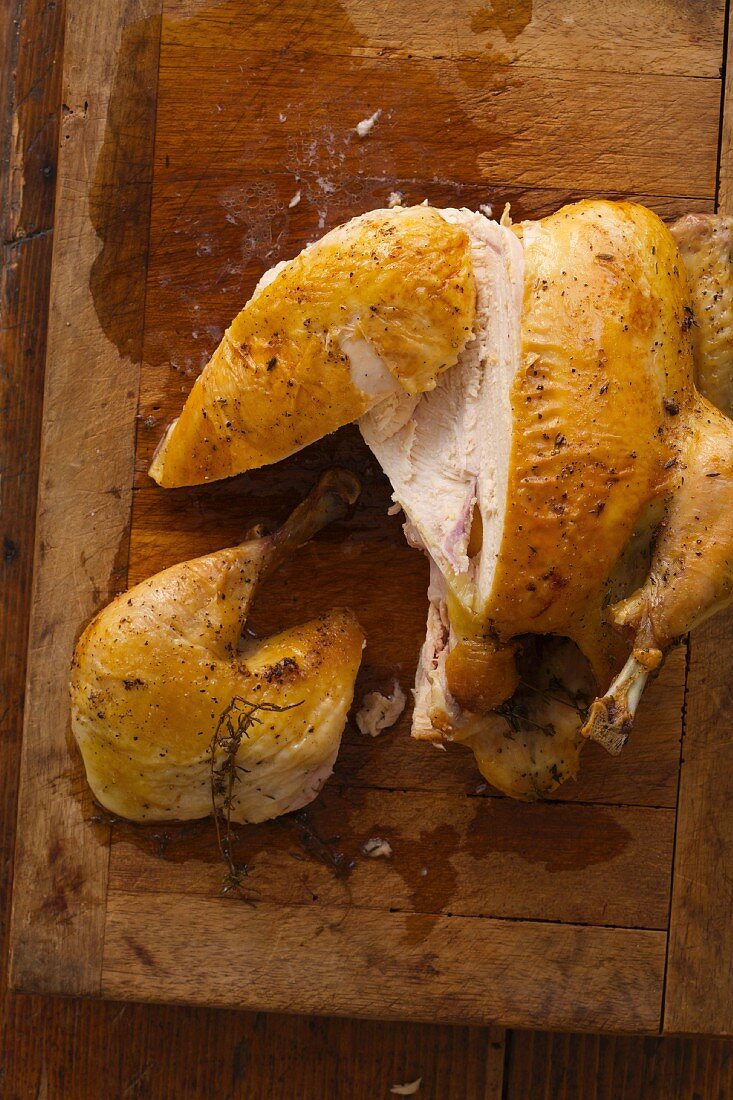 Roasted Chicken on a Wooden Cutting Board Sliced