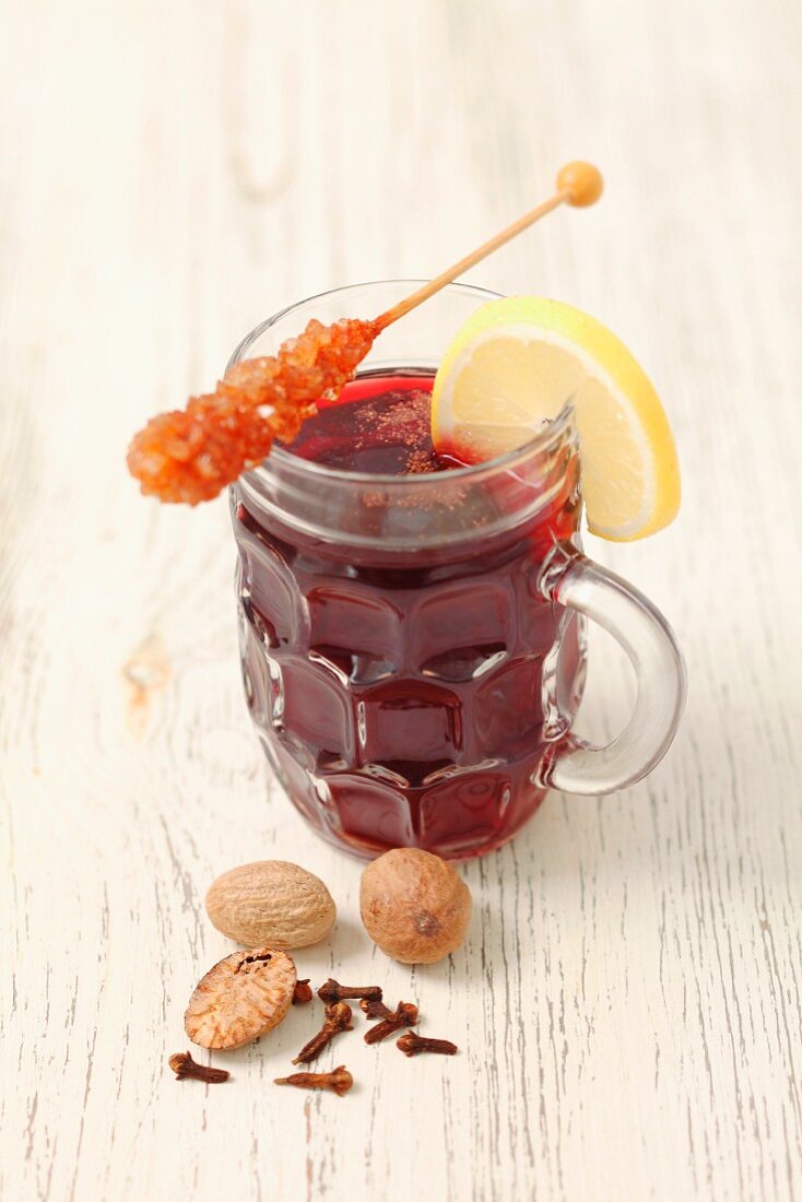 Red mulled wine with nutmeg and a rock sugar swizzle