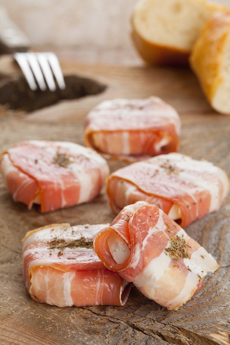 Young goat's cheese wrapped in bacon with herbes de Provence