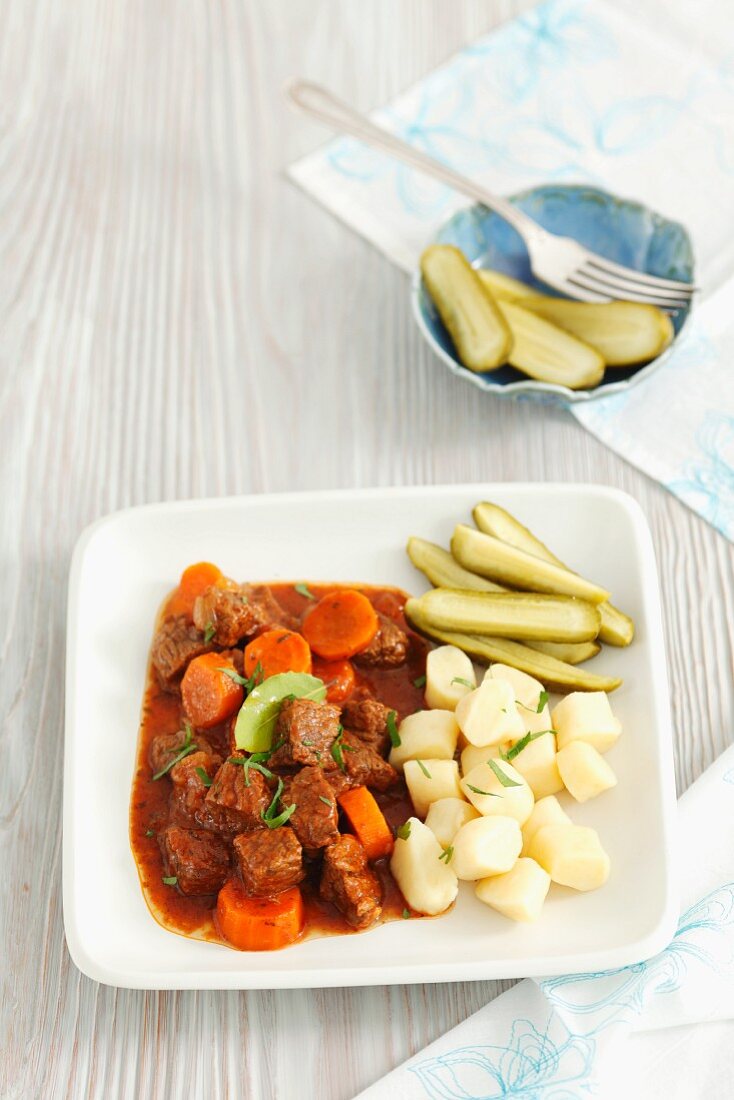 Beef stew with carrots, potato gnocchi and pickled gherkins