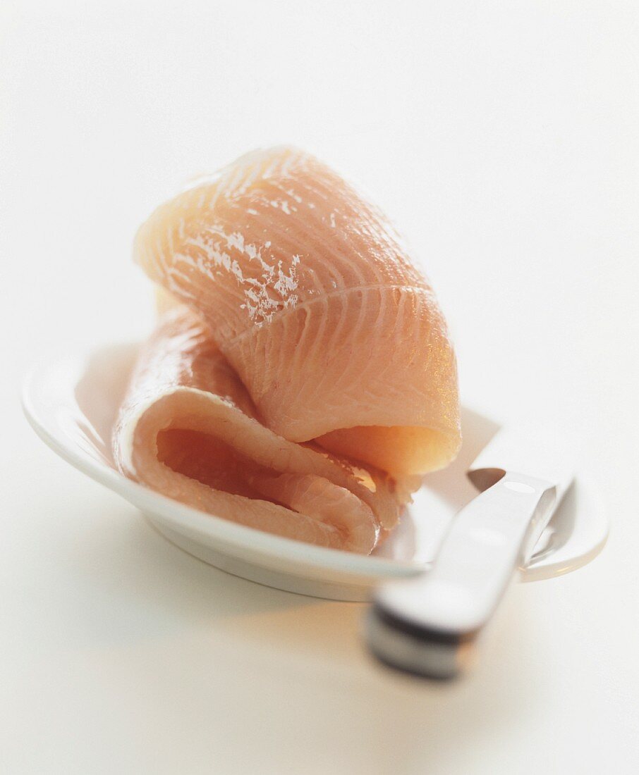 Raw fish fillets on a plate