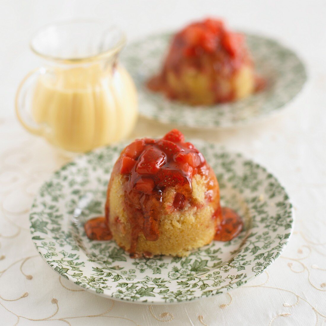 Steamed pudding with strawberries and vanilla sauce
