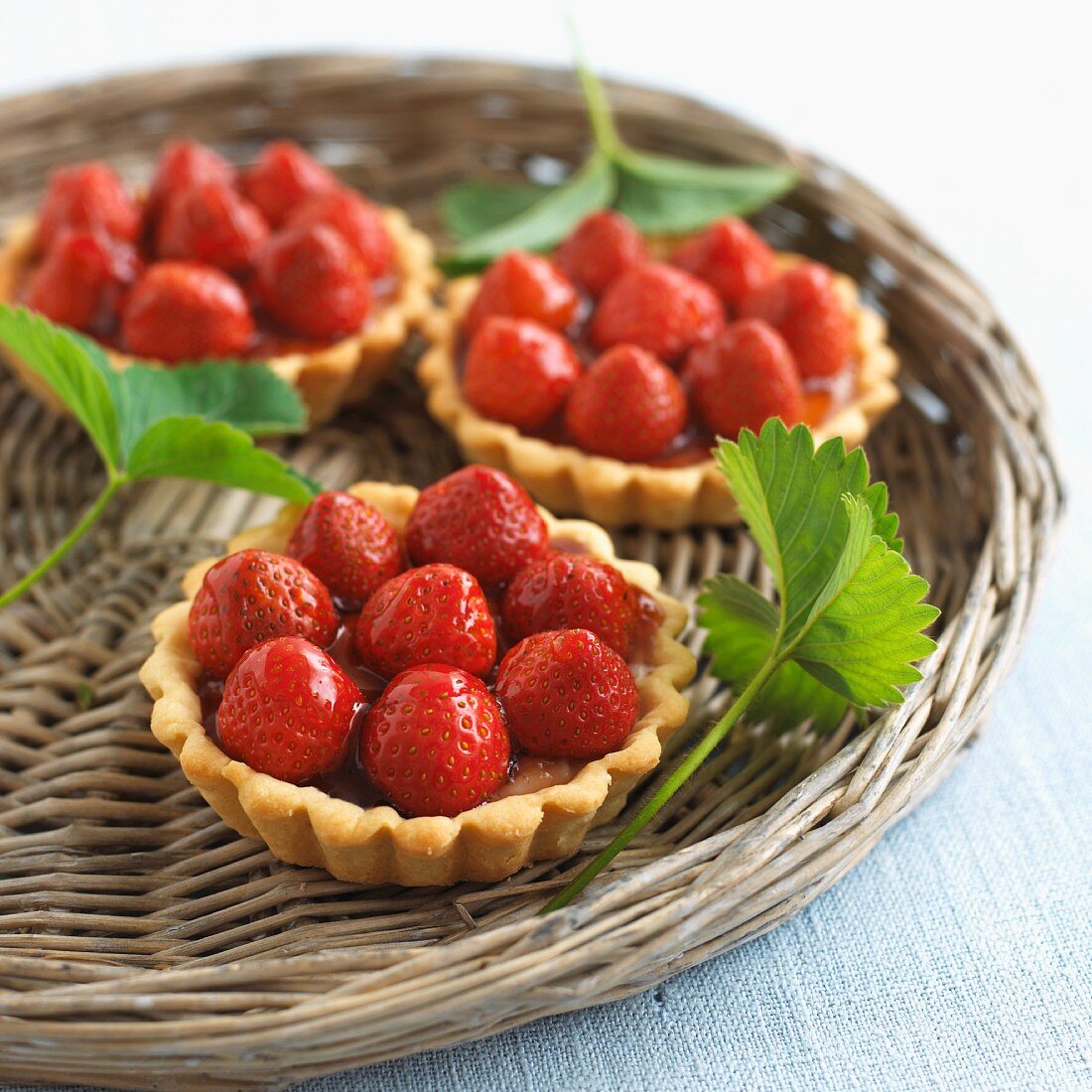 Strawberry tartlets on a wicker tray