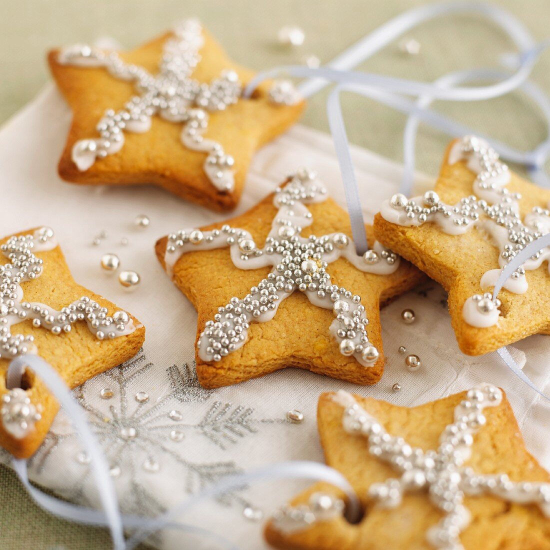 Gingerbread stars with silver pearls as Christmas ornaments