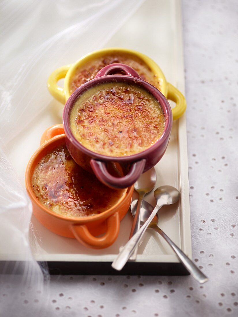 Creme brulee in three, colorful ceramic dishes