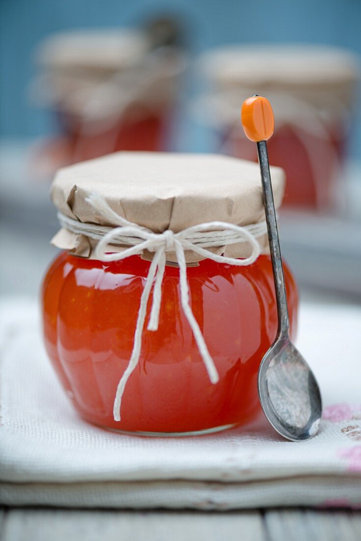 Papaya marmalade in a twist top glass jar