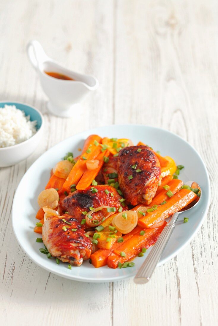 Chicken leg with carrots and oranges