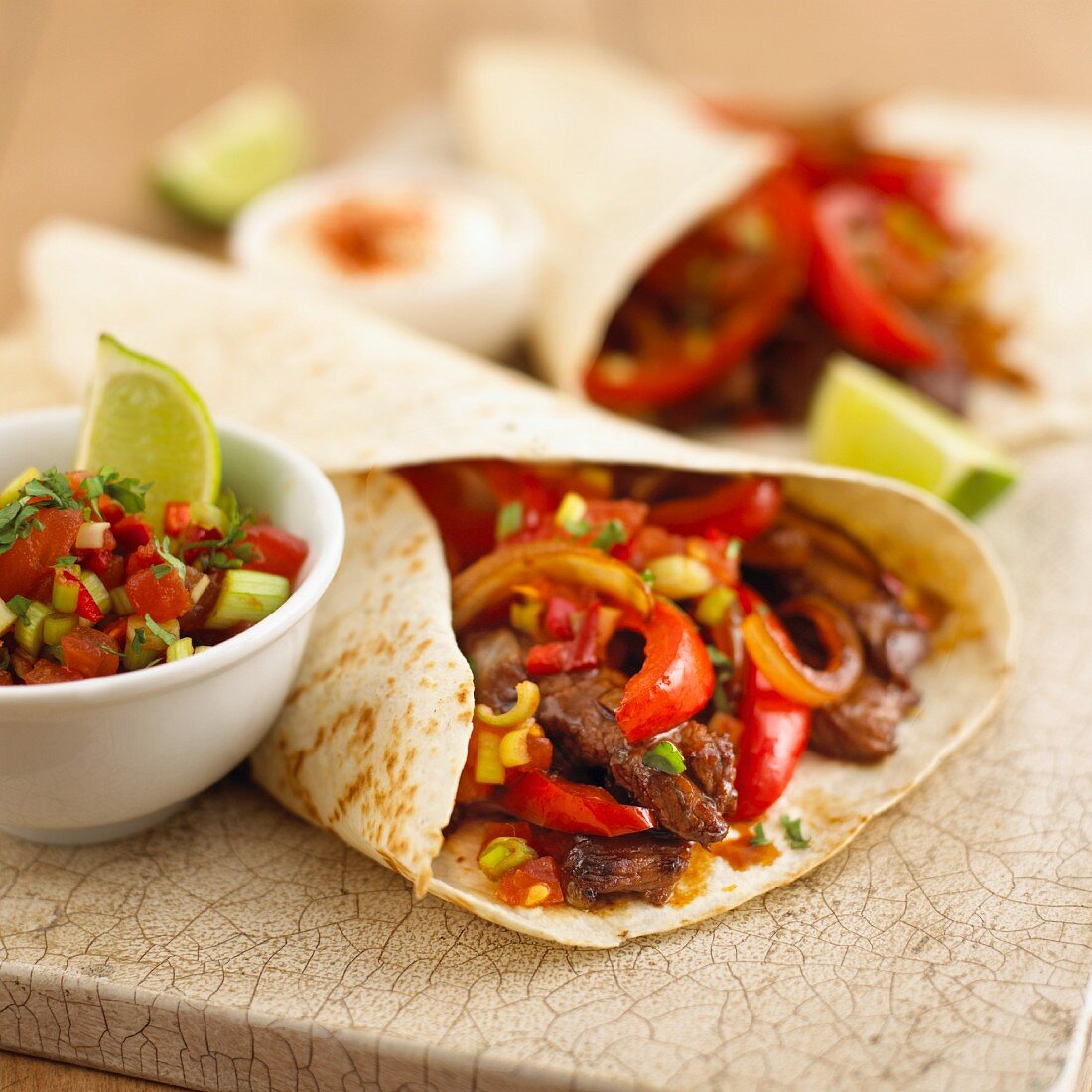 Wraps with beef, peppers and onions