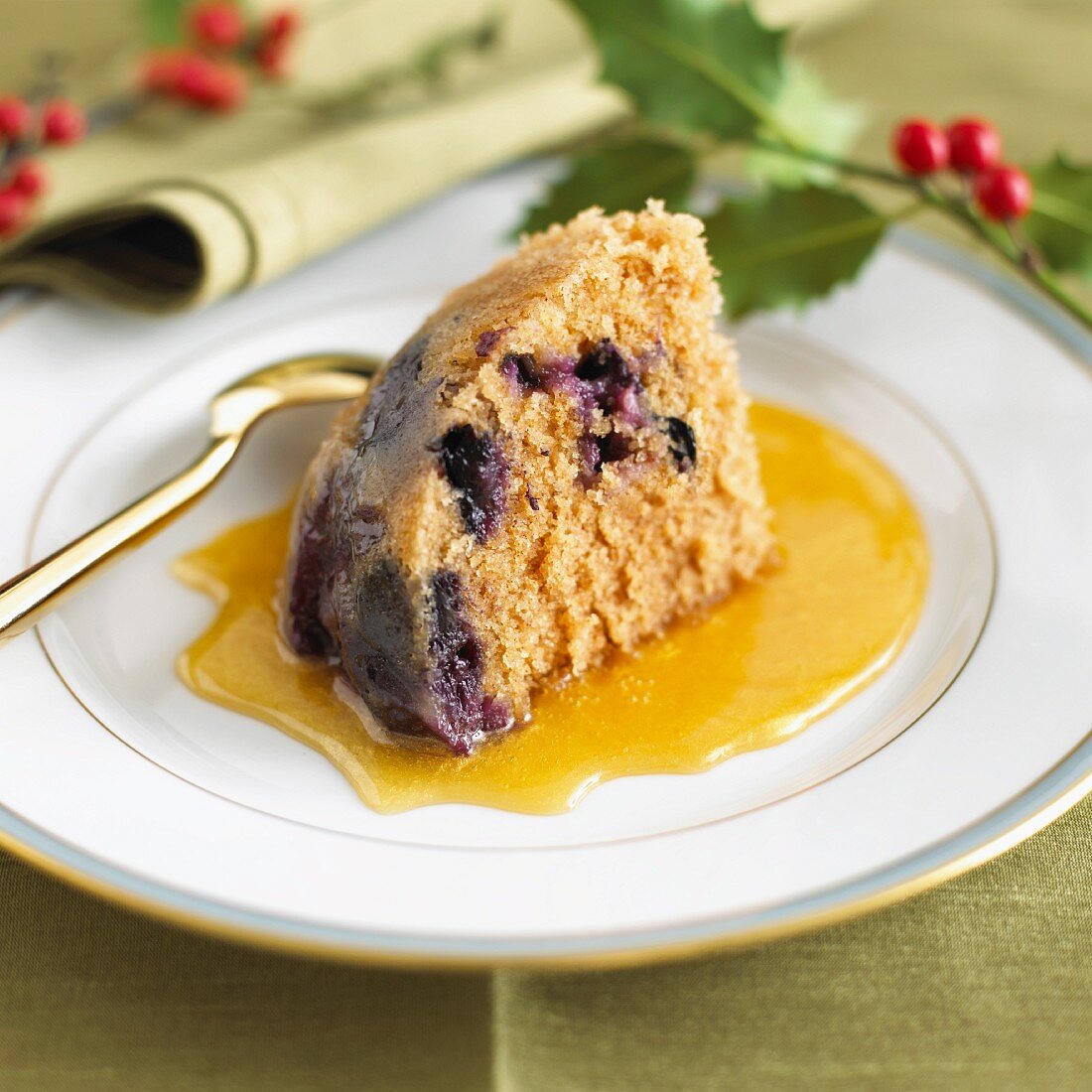A piece of blueberry pudding with honey sauce