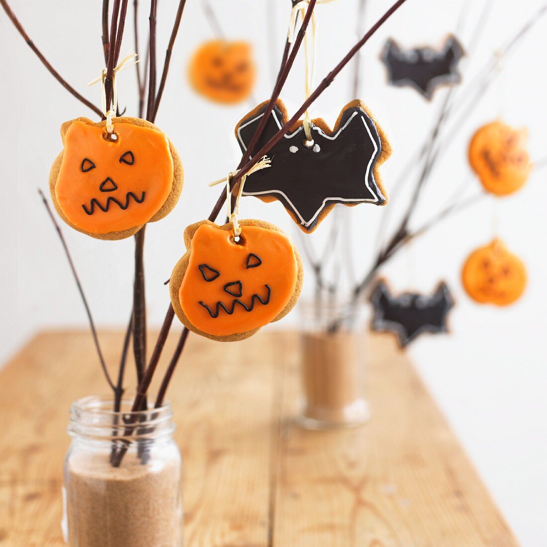 A variety of Halloween cookies hanging on branches