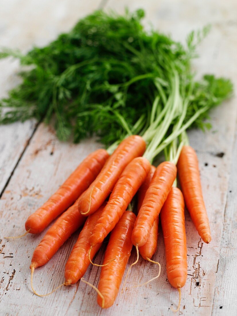 Fresh carrots on wooden background