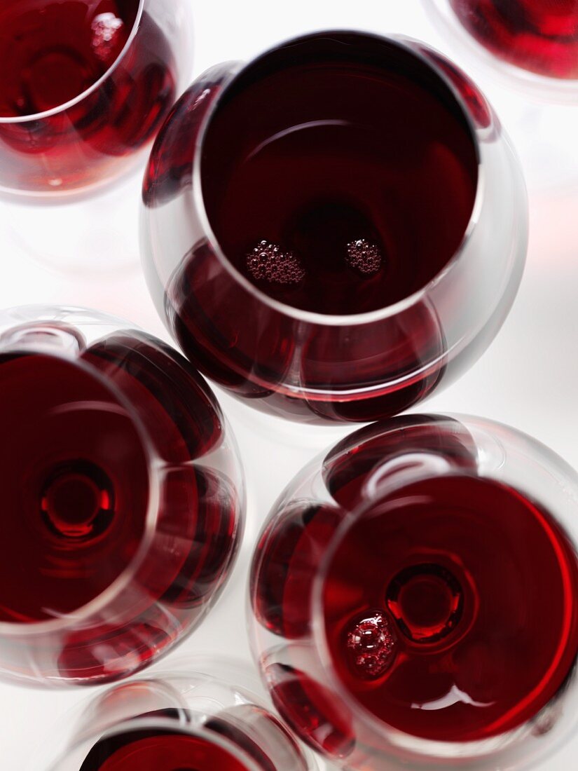 Several glasses of red wine seen from above