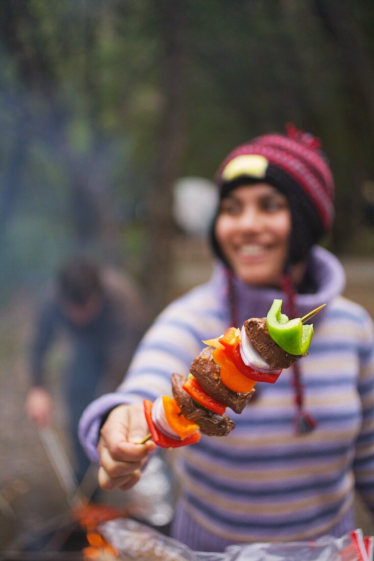 A Woman Holding a Kabob