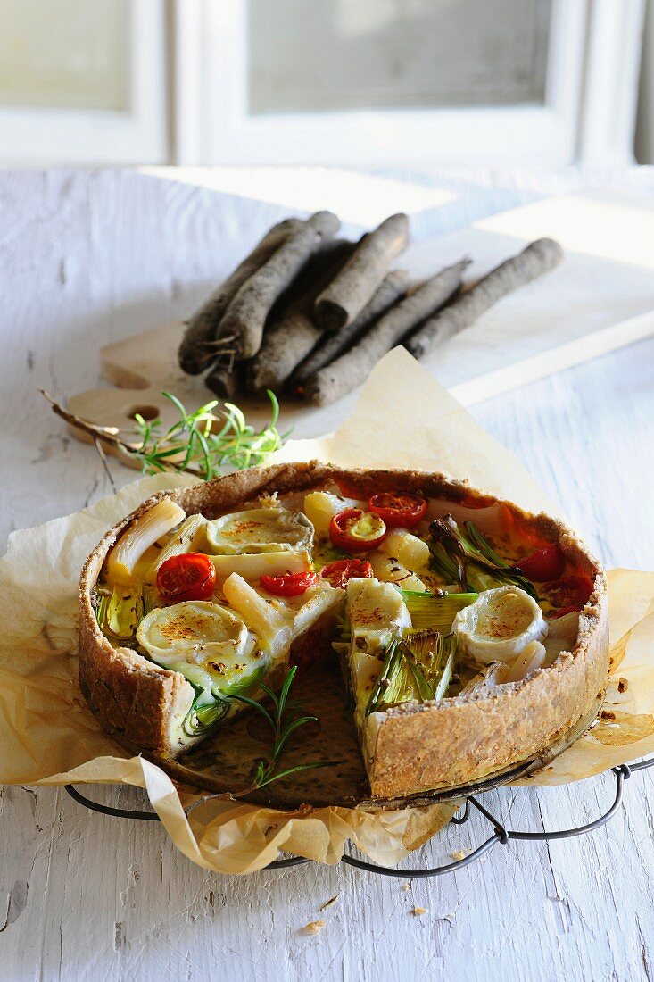 Black salsify quiche with cherry tomatoes and goat cheese