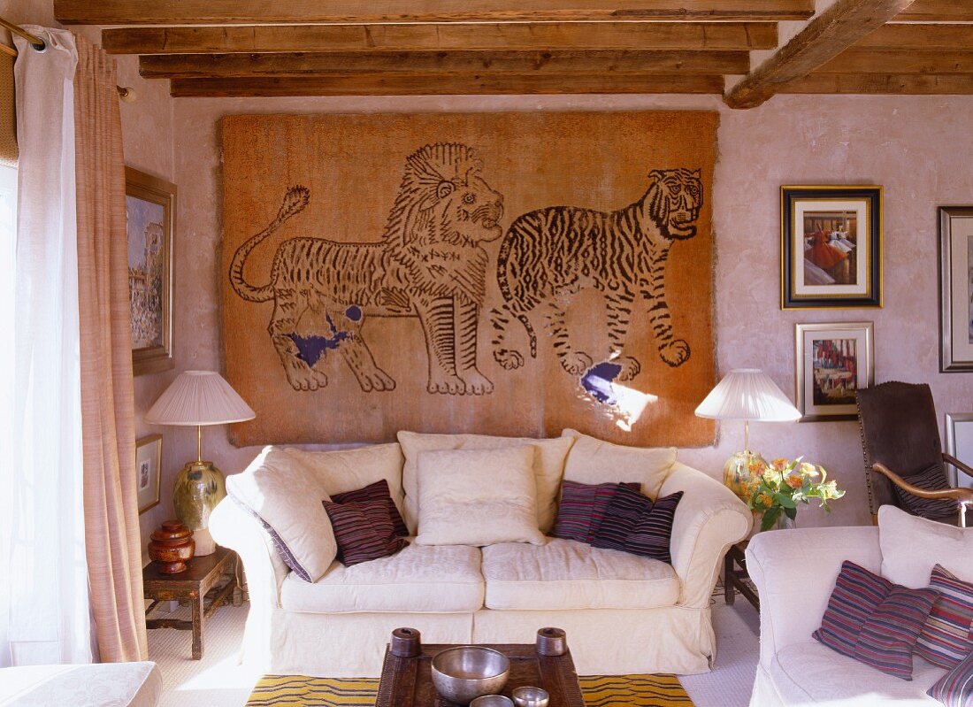 A bright living room in an English country house with a sofa and hand-knotted wall hanging from China