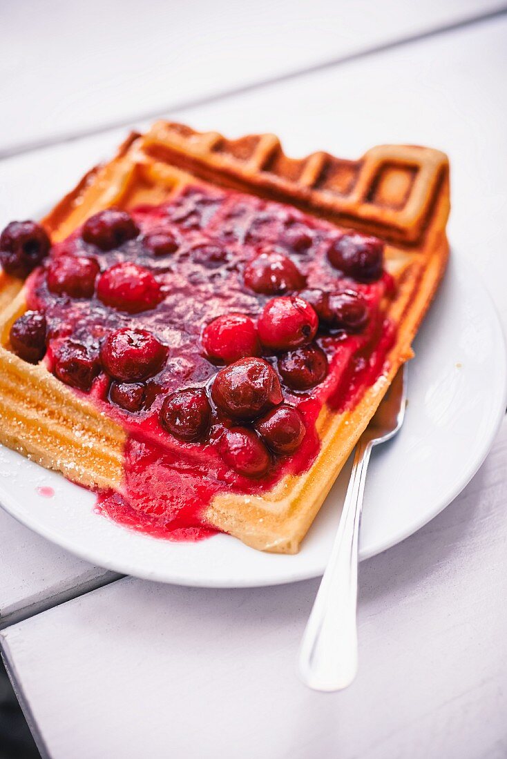 Waffle with cherry sauce