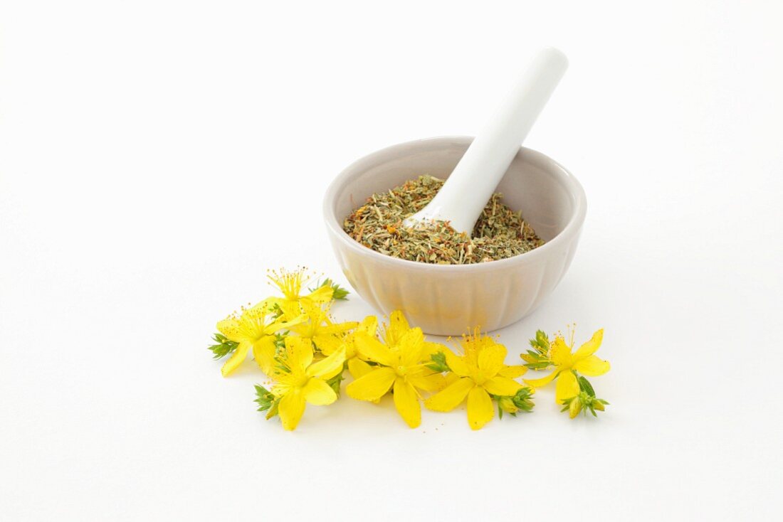 St. John's wort flowers and a mortar with dried herbs