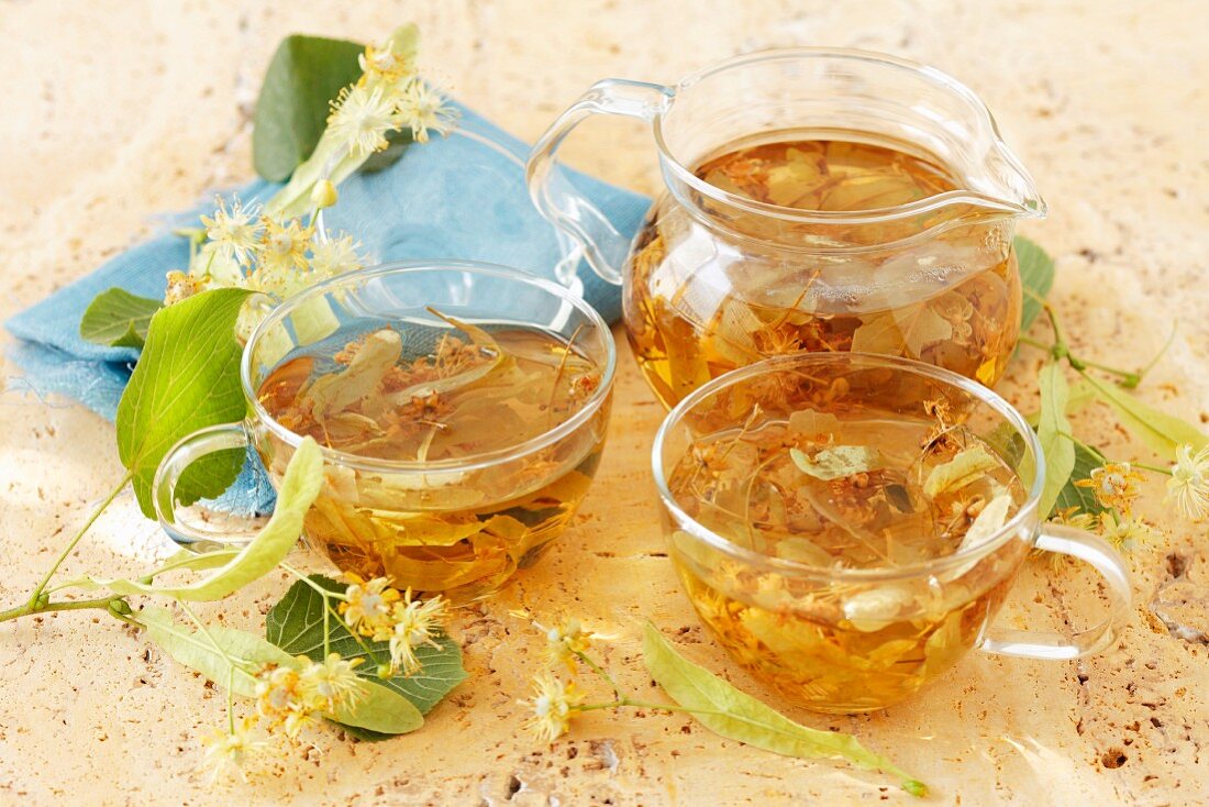 Limeflower tea in a glass jug and glass teacups