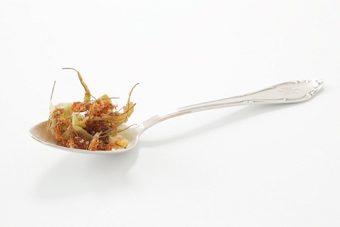 Dried lime flowers on a spoon