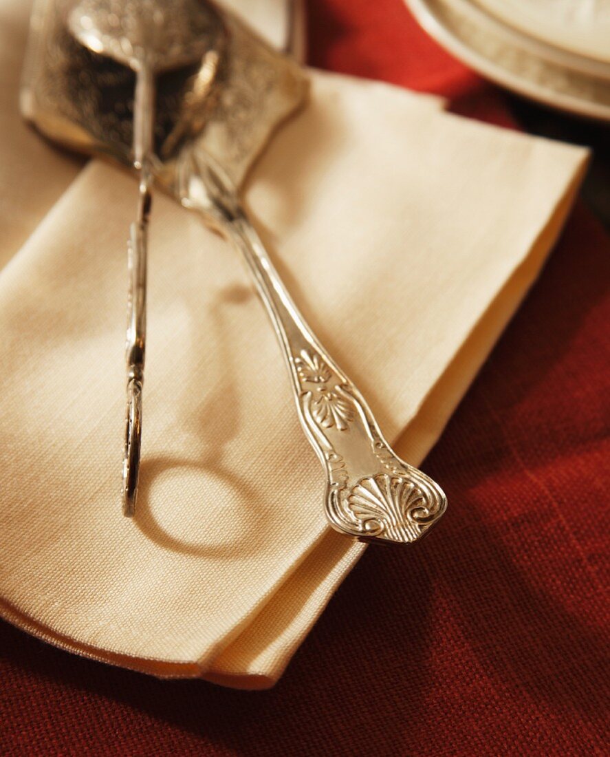 Antique cake serving knives on linen napkins, Close Up