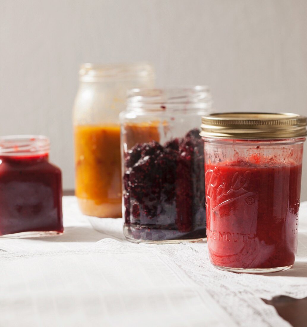 Jars of assorted jams and chutneys (Strawberry jam, Mulberry jam, Mango chutney, spicy plum sauce)