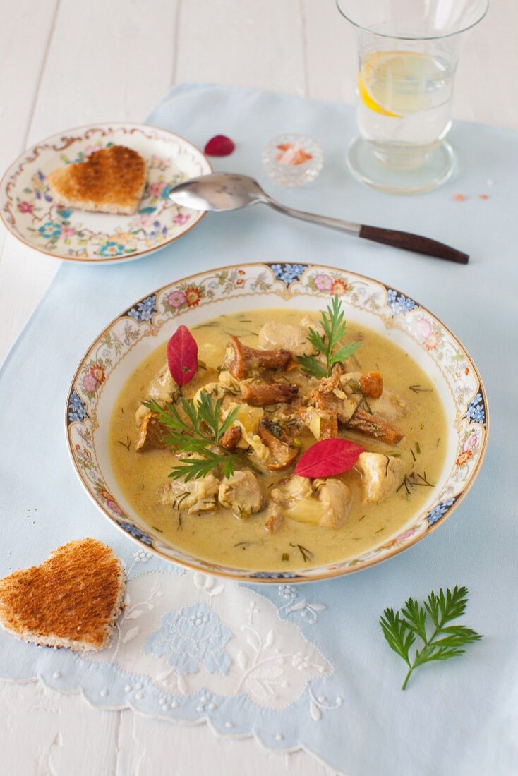 A Bowl of Turkey Soup with Mushrooms with Heart Shaped Toasts