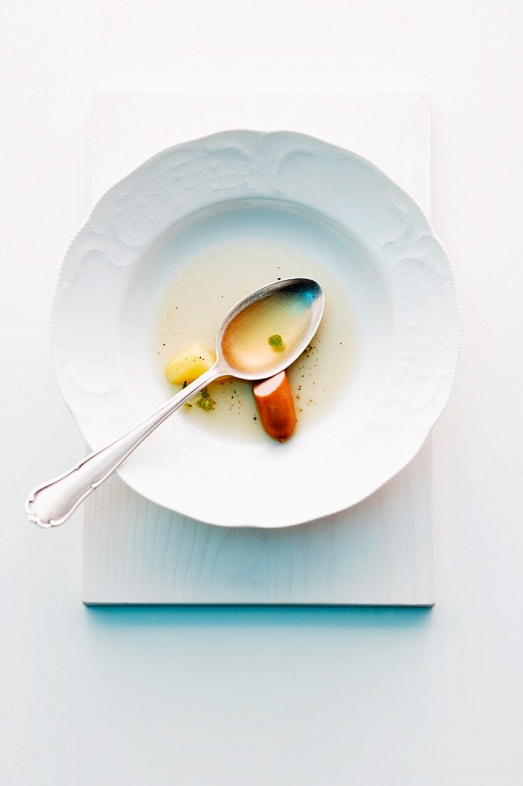 A plate with the remains of soup