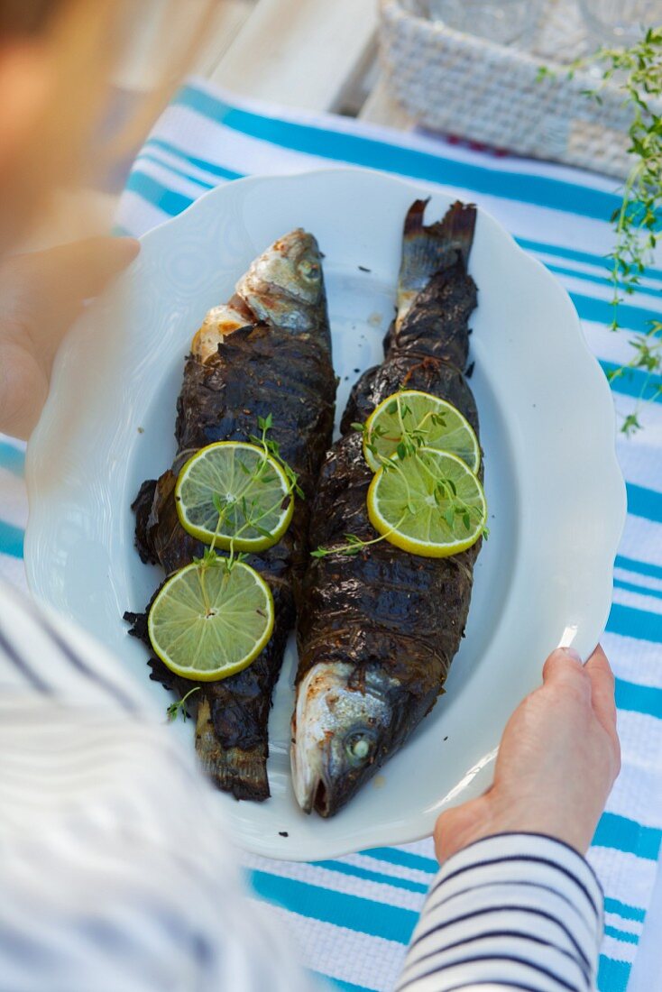 Grilled trout wrapped in vine leaves
