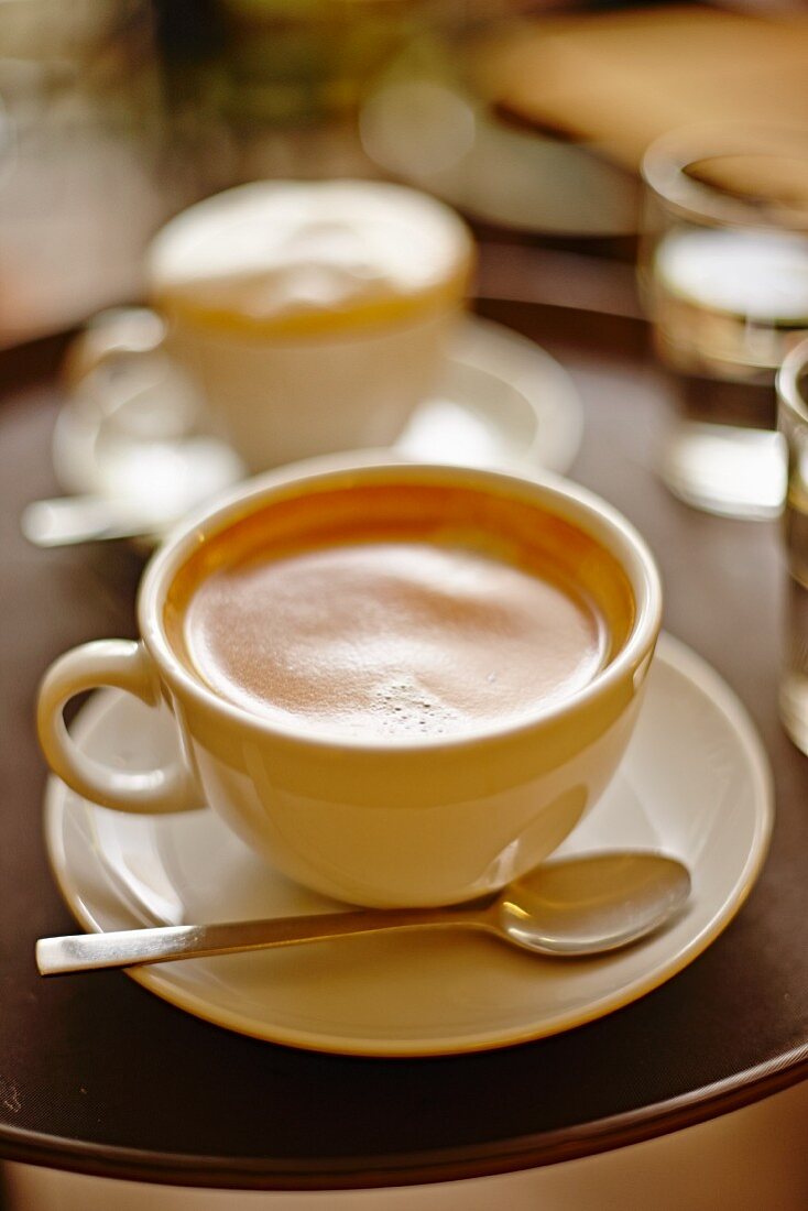 Two cups of cappuccino on a tray