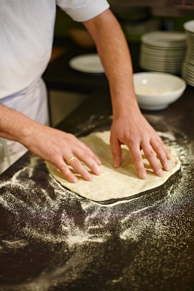 Pizza dough being stretched