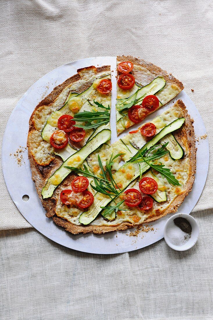Tarte flambée with courgette, tomatoes and rocket