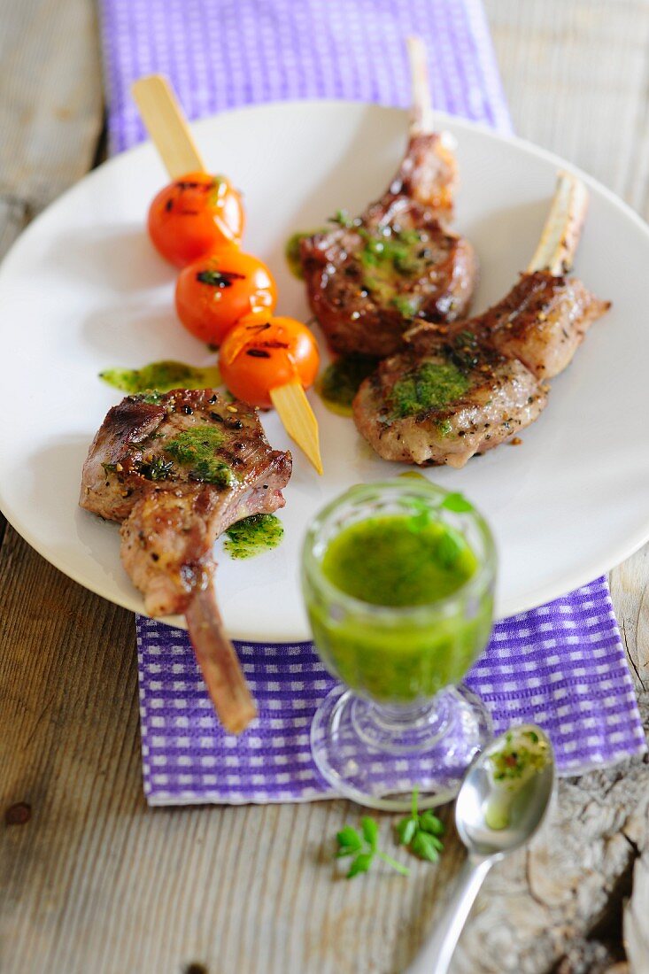 Grilled lamb chops with a tomato skewer and pesto