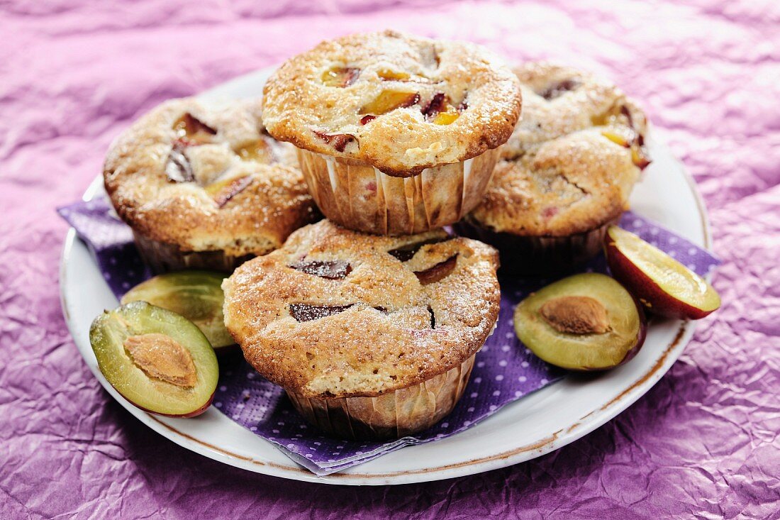 Plum and Walnut Muffins on purple background, selective focus