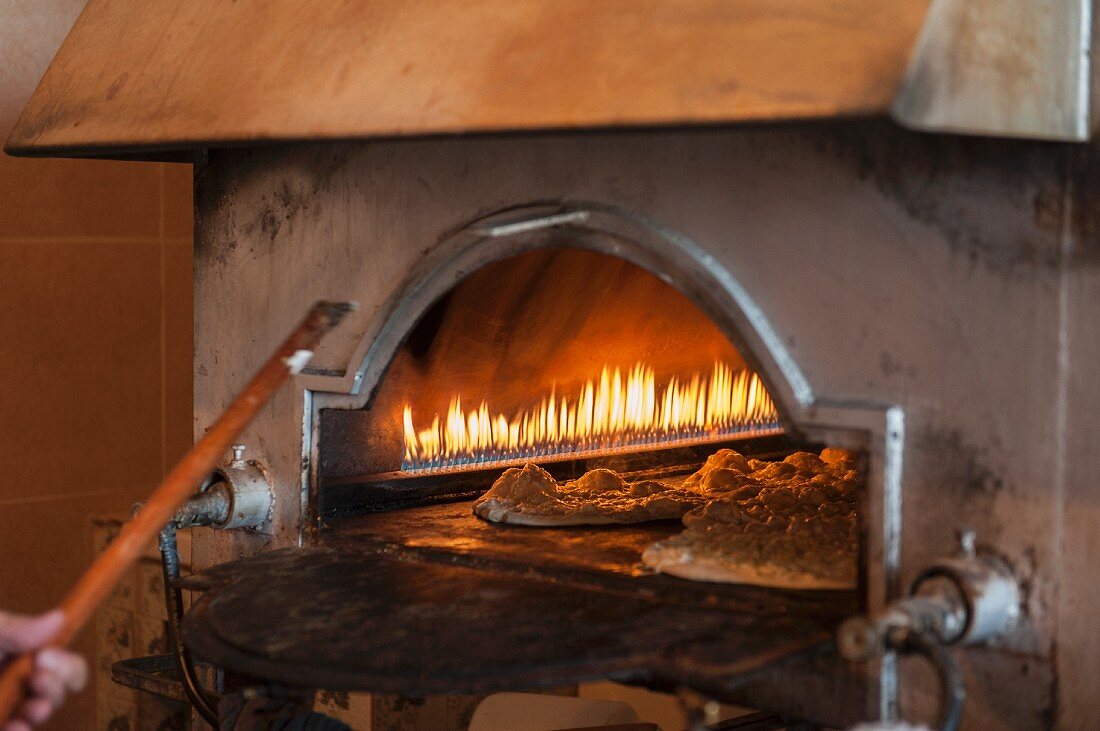 Lebanese flatbread with cheese being baked in the oven