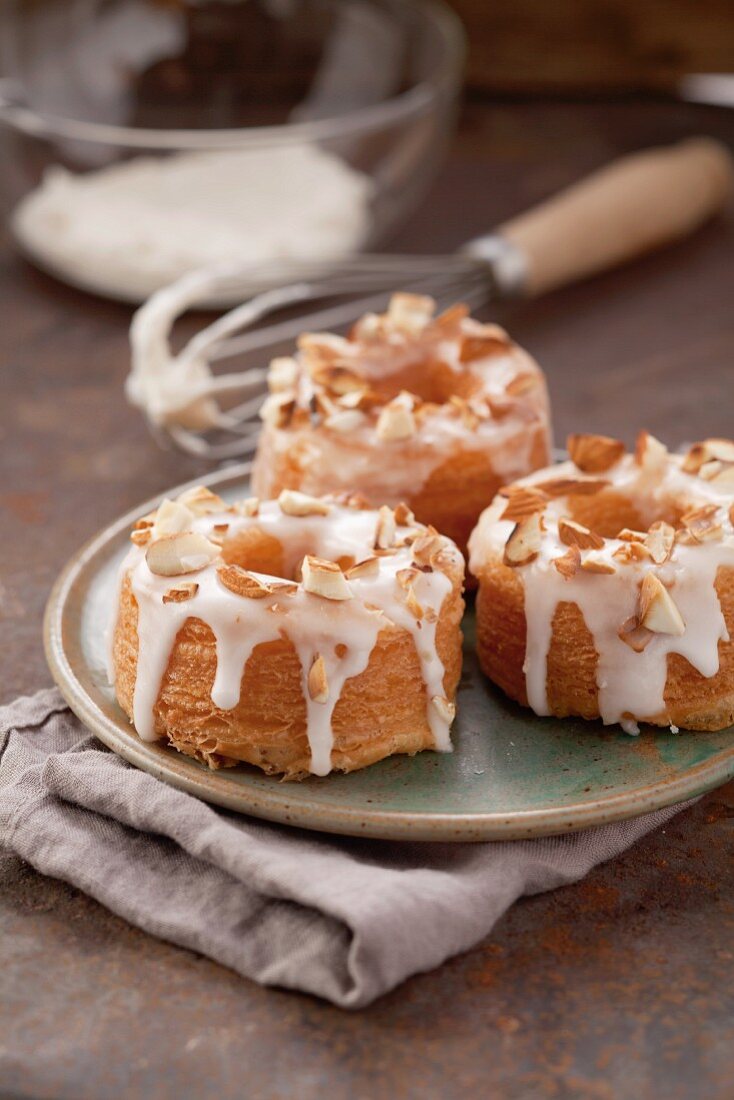 Amaretto doughnuts with sugar glaze and almond pieces