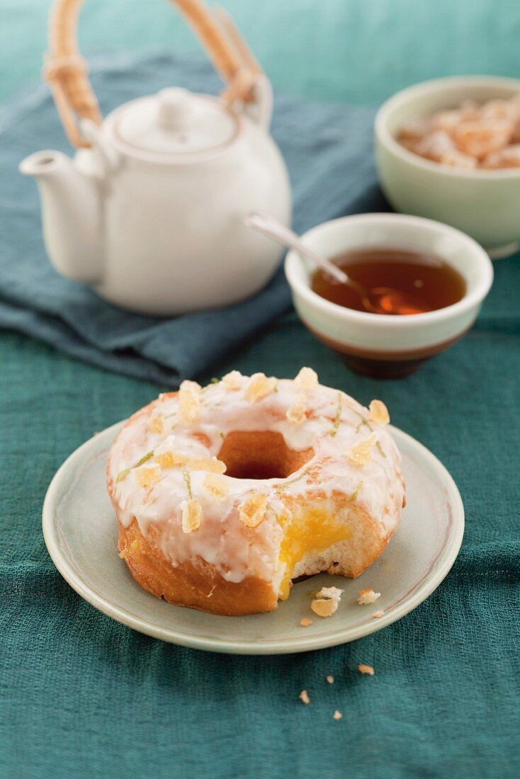 Doughnut with candied ginger pieces and sugar glaze