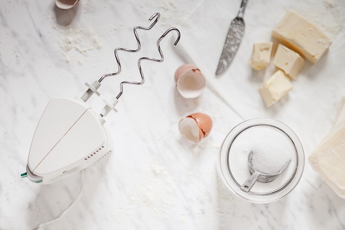 Baking ingredients with a hand mixer, sugar and butter