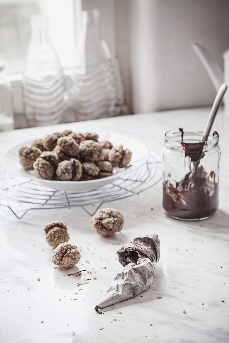 Espresso and walnut cookies being filled with nut nougat cream