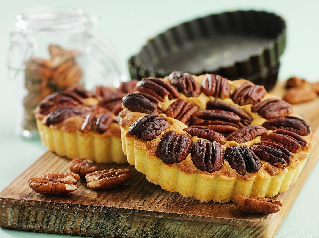 Small pecan nut tartlets on a chopping board