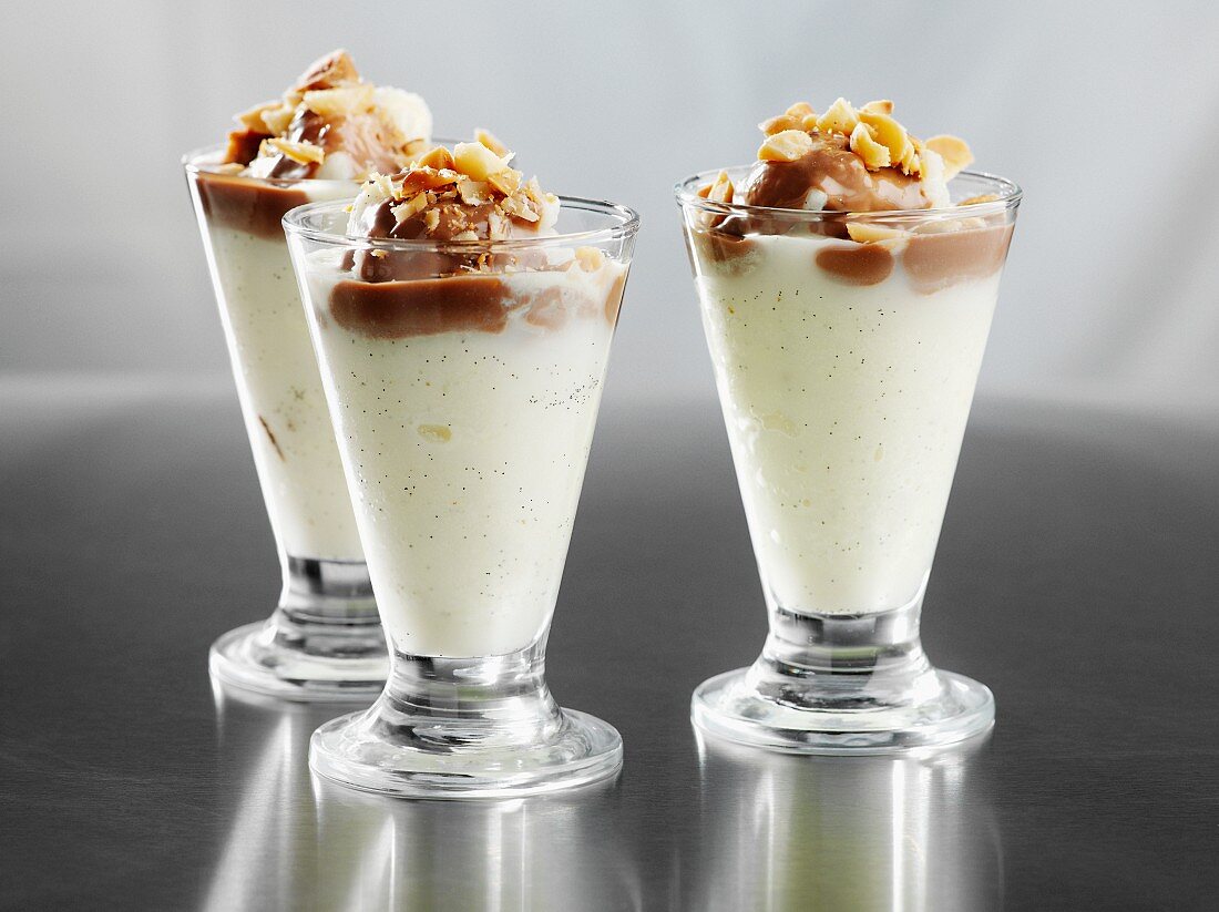 Vanilla ice cream sundaes with chocolate sauce and nuts