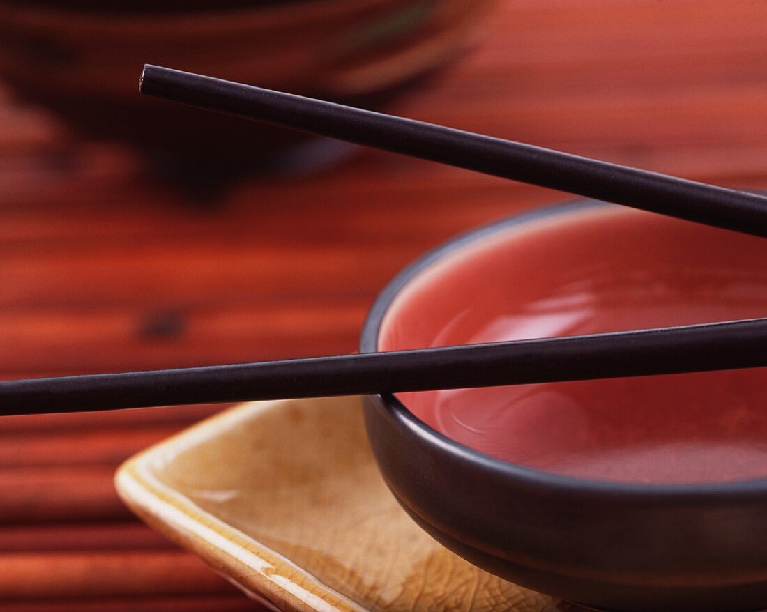 An oriental bowl with chopsticks (close-up)