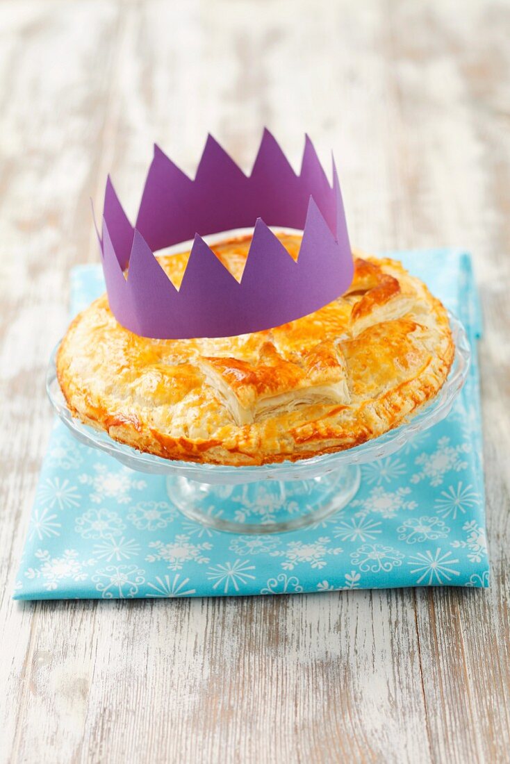 Galette des Rois (king cake) with a paper crown