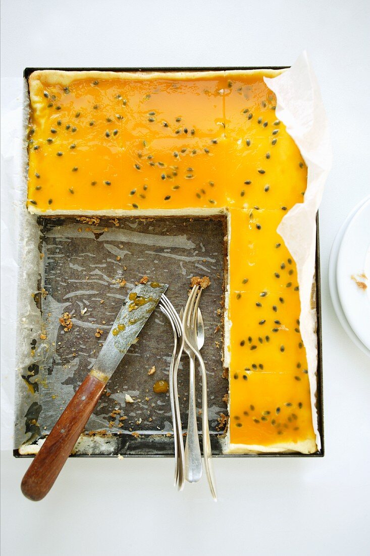 Tray-baked cheesecake with passion fruit sauce