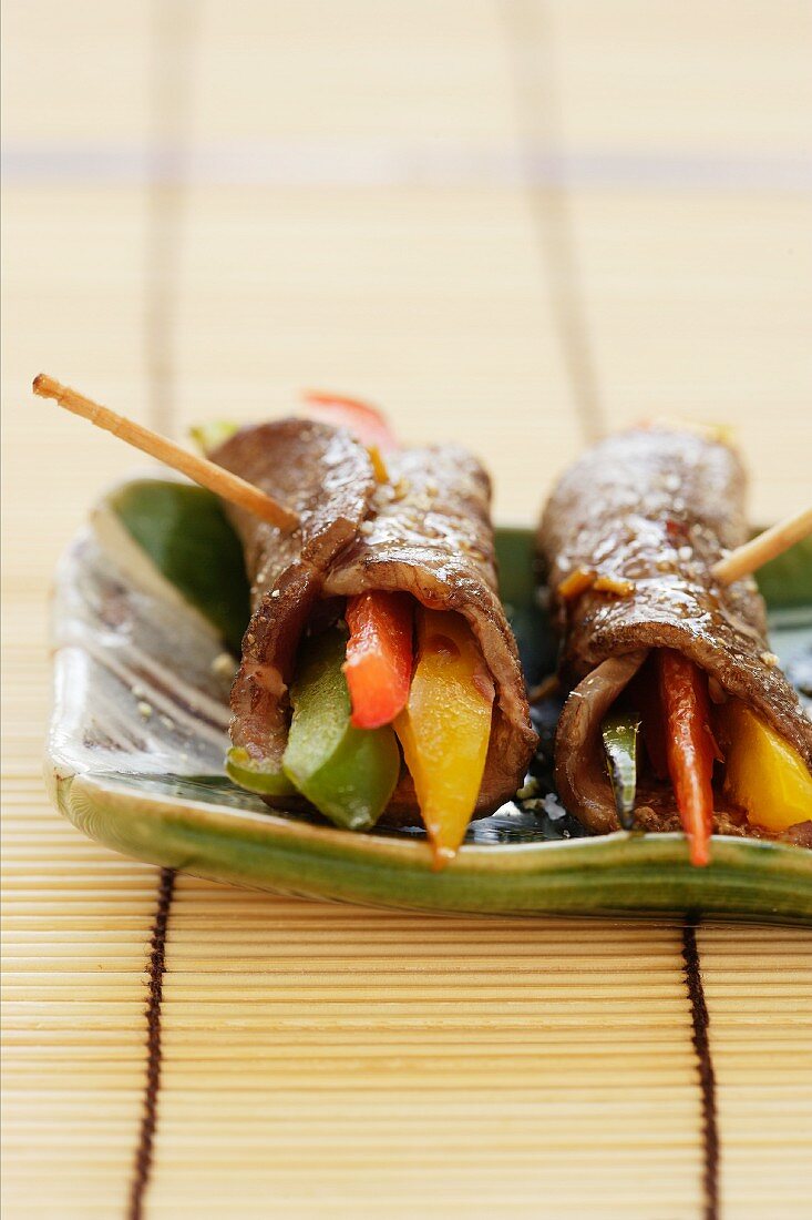 Rolled slices of beef filled with colourful strips of pepper