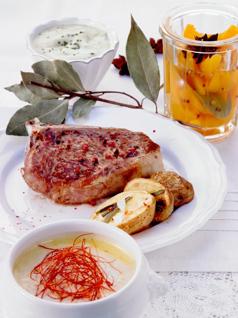 A meal of chilli soup, a veal chop and preserved peaches