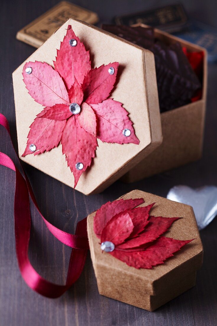 Colourful autumn leaves stuck on gift boxes